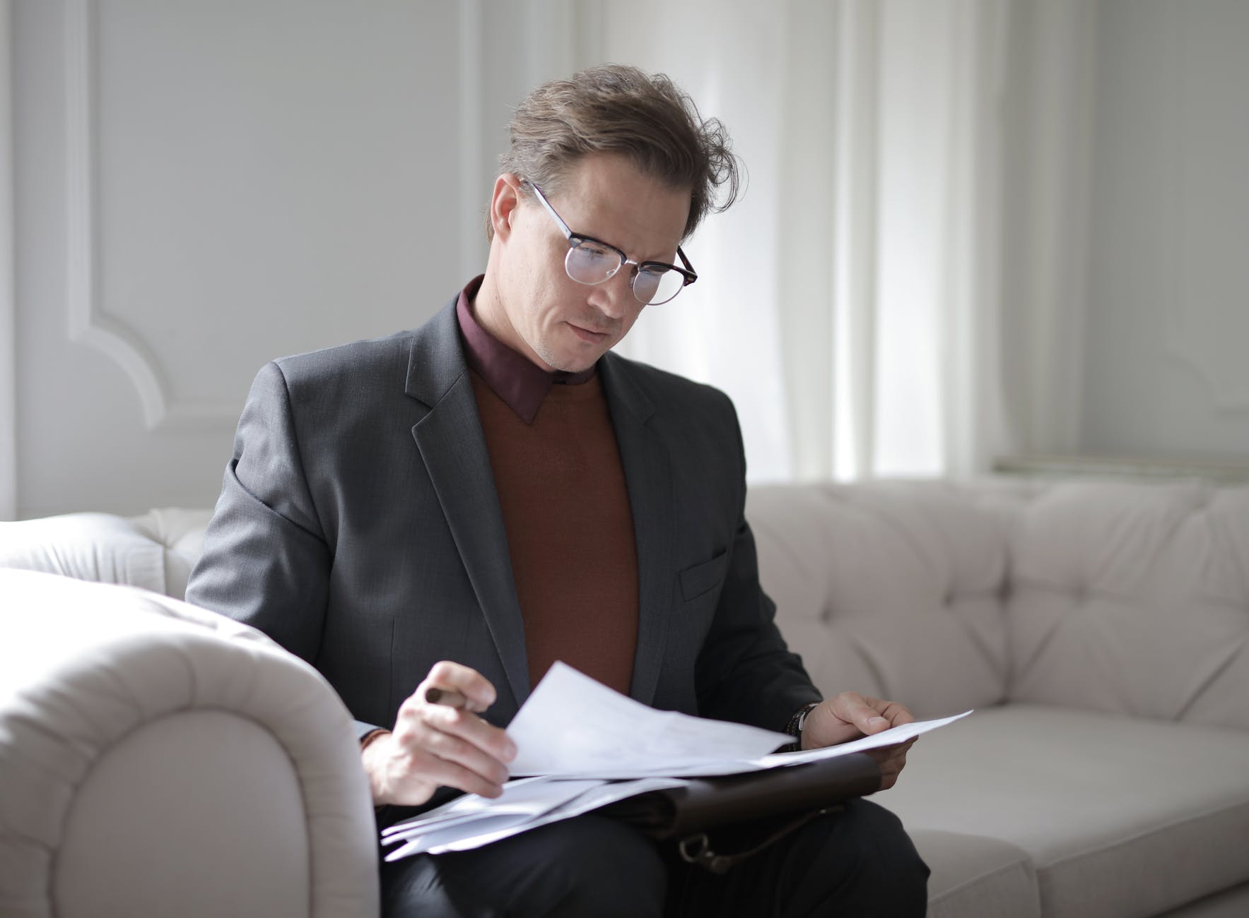 man reading a pile of papers